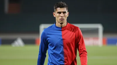 Mid-20s anonymous midfielder, athletic build, waist-up, intense gaze, face fully visible, wearing a plain, unmarked...